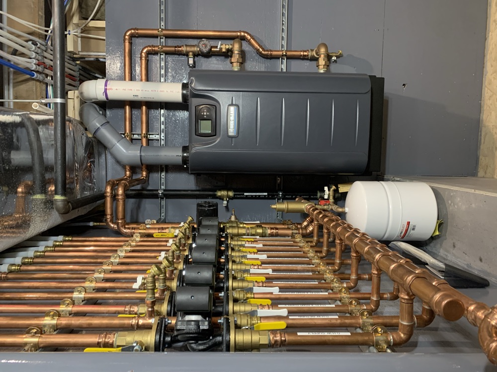 Detailed copper manifold with circulator pumps