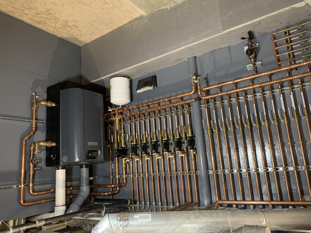 Tankless system with clean copper distribution piping